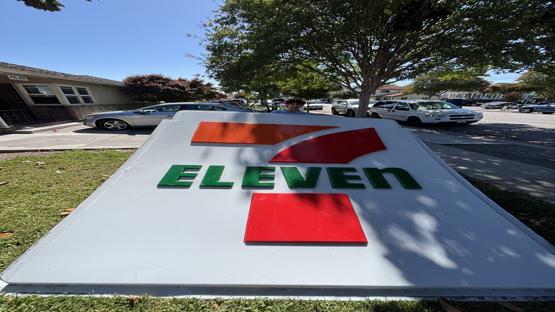 Marcus behind a 7-Eleven sign